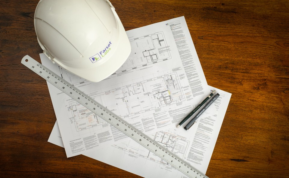 Farset hardhat, blueprints for the 2019 renovation, along with ruler and pencil/pen